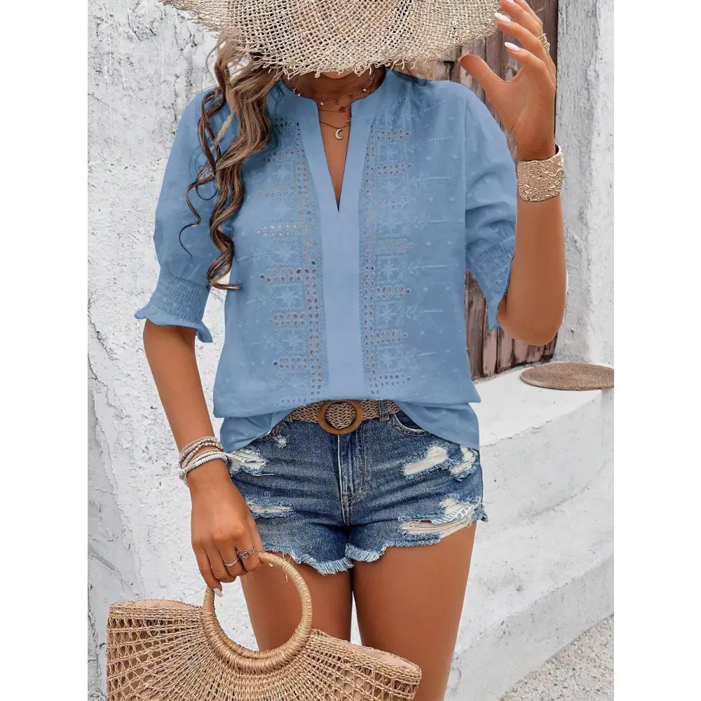 Light blue embroidered blouse with v-neck and three-quarter sleeves featuring puff sleeve and white eyelet details