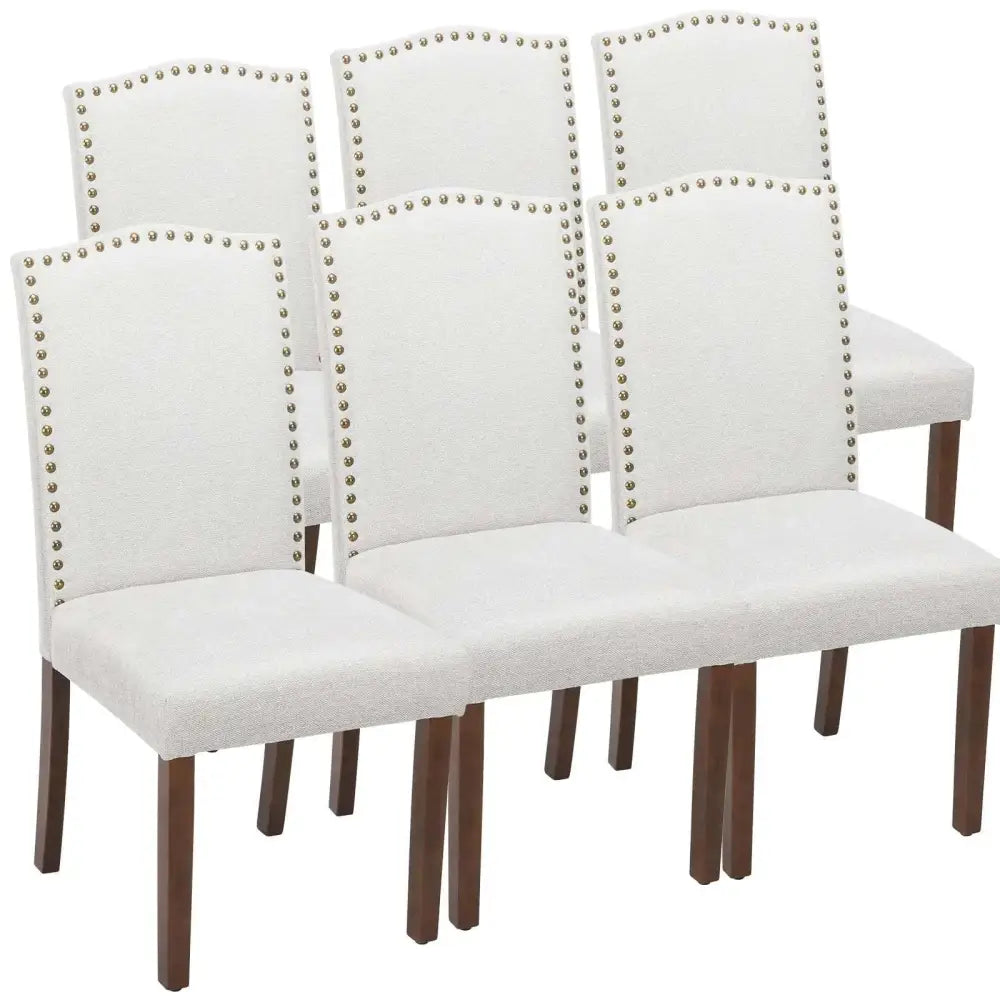 Set of six white fabric dining chairs with silver nailhead trim and dark wood legs dining chairs set