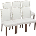 Set of six white fabric dining chairs with silver nailhead trim and dark wood legs dining chairs set