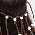 Brown braided leather hair tie with white wooden beads complementing elegant white feather hairband accessories