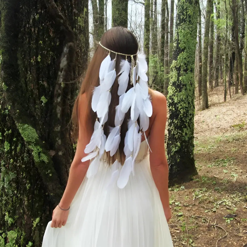 A white featherhead bohemia wedding bridal hair band featuring a delicate white feather and natural-toned band