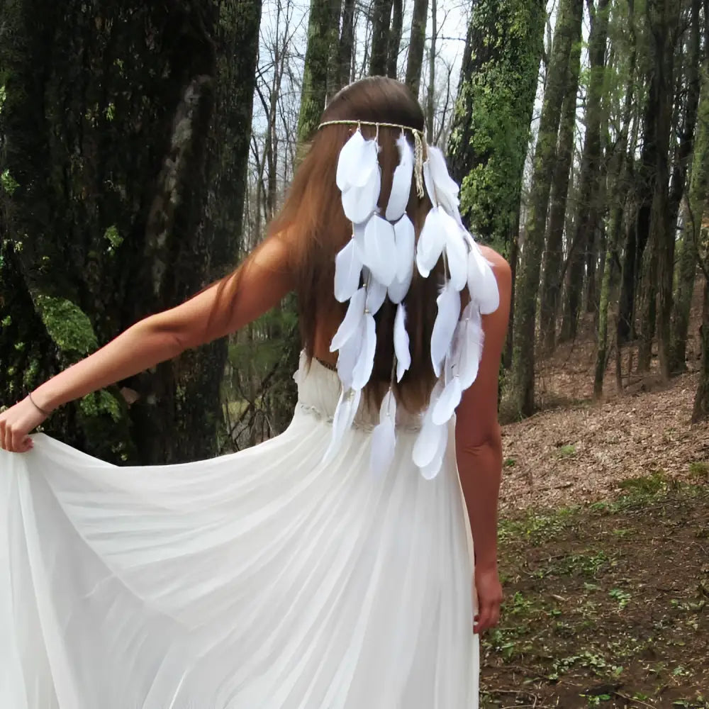 White featherhead bohemia wedding bridal hair band featuring delicate cascading white feathers and a thin metallic band