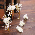 Elegant white floral handmade wreath headwear with gold wire and crystal accents for bridal or formal wear