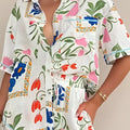 White floral slim fit short sleeve shirt dress with vibrant pink blue and orange flowers on green stems