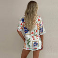 White floral slim fit short sleeve shirt set featuring colorful embroidered flowers and decorative borders on fabric