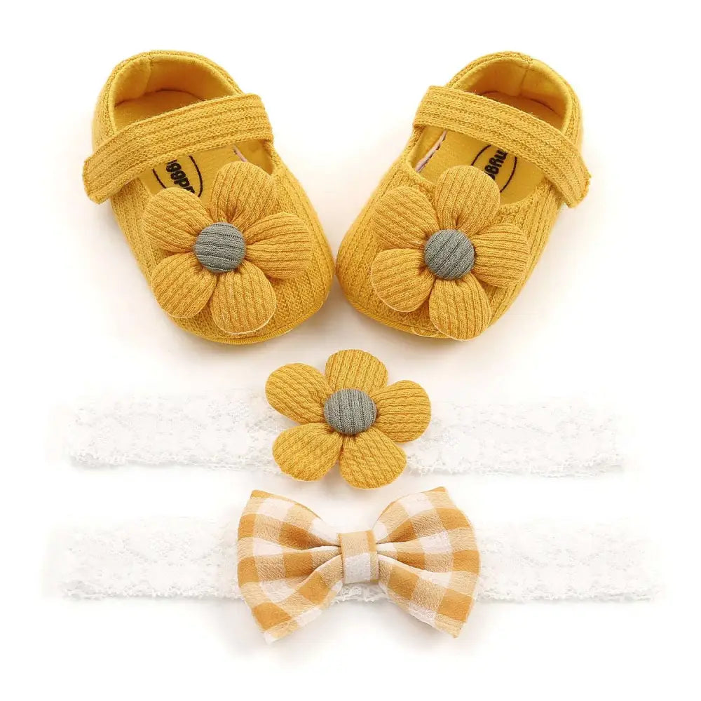 White flower princess baby shoes with yellow knitted flower embellishments and gray centers for baby and toddler use