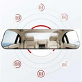 A sleek glass white mirror rearview driving recorder with black frame reflecting beige leather car interior