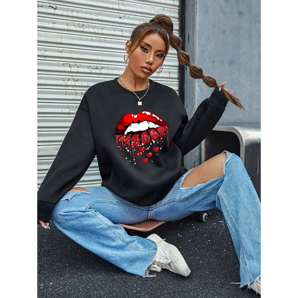 Black pocketed long sleeve sweatshirt featuring bold red glittery lips with dripping effect and small heart details