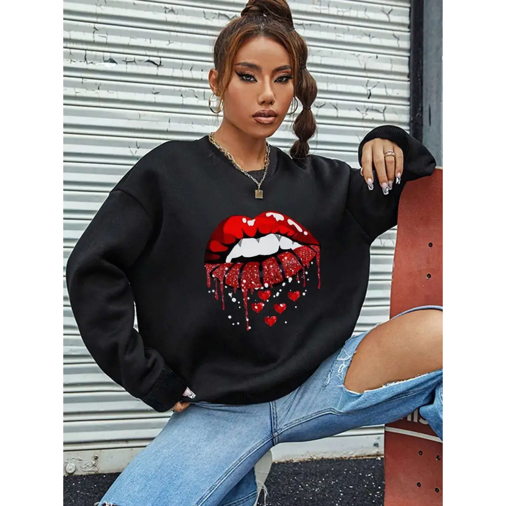 Black pocketed long sleeve sweatshirt featuring bold red glittery lips with dripping effect and small hearts below