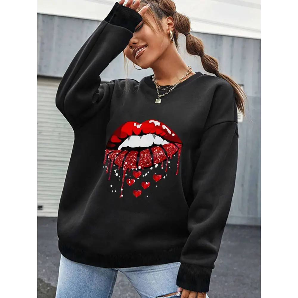 Black pocketed long sleeve sweatshirt featuring bold red glittery lips with dripping hearts graphic design