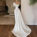 White graceful satin off-the-shoulder wedding dress with delicate beaded embellishments and a flowing train