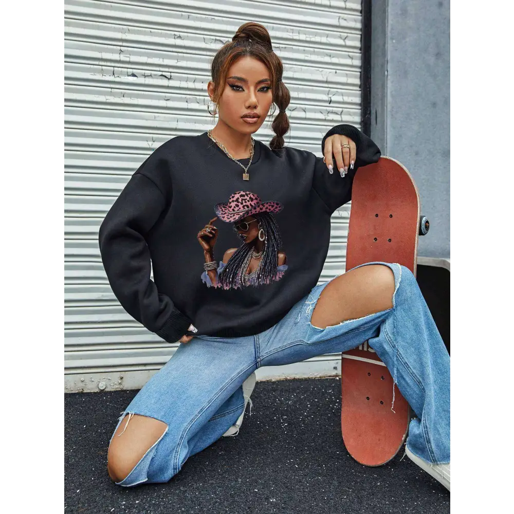 Black oversized long sleeve sweatshirt featuring a vibrant white graphic leopard hat design with pink accents