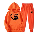 Orange hooded sweatshirt and joggers set featuring white heart paw printed hoodie design in comfortable fabric