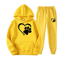 Bright yellow hooded sweatshirt and joggers set with black white heart paw printed hoodie graphics