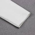 A crisp white fabric napkin with subtle woven texture displayed alongside a white high neck chest scheming hip short skirt