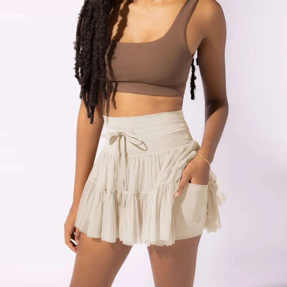 Beige waist pleated skirt with drawstring and side pockets featuring built-in safety pants summer design