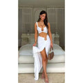 White high waist sheath skirt suit with cutout top and gold toned hardware paired with white fendi handbag