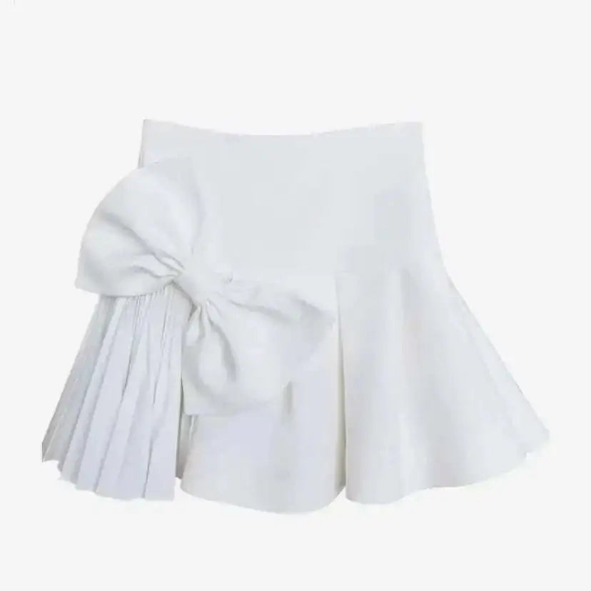White high waist slimming pleated skirt with a large voluminous waist slimming bow and elegant skirt length