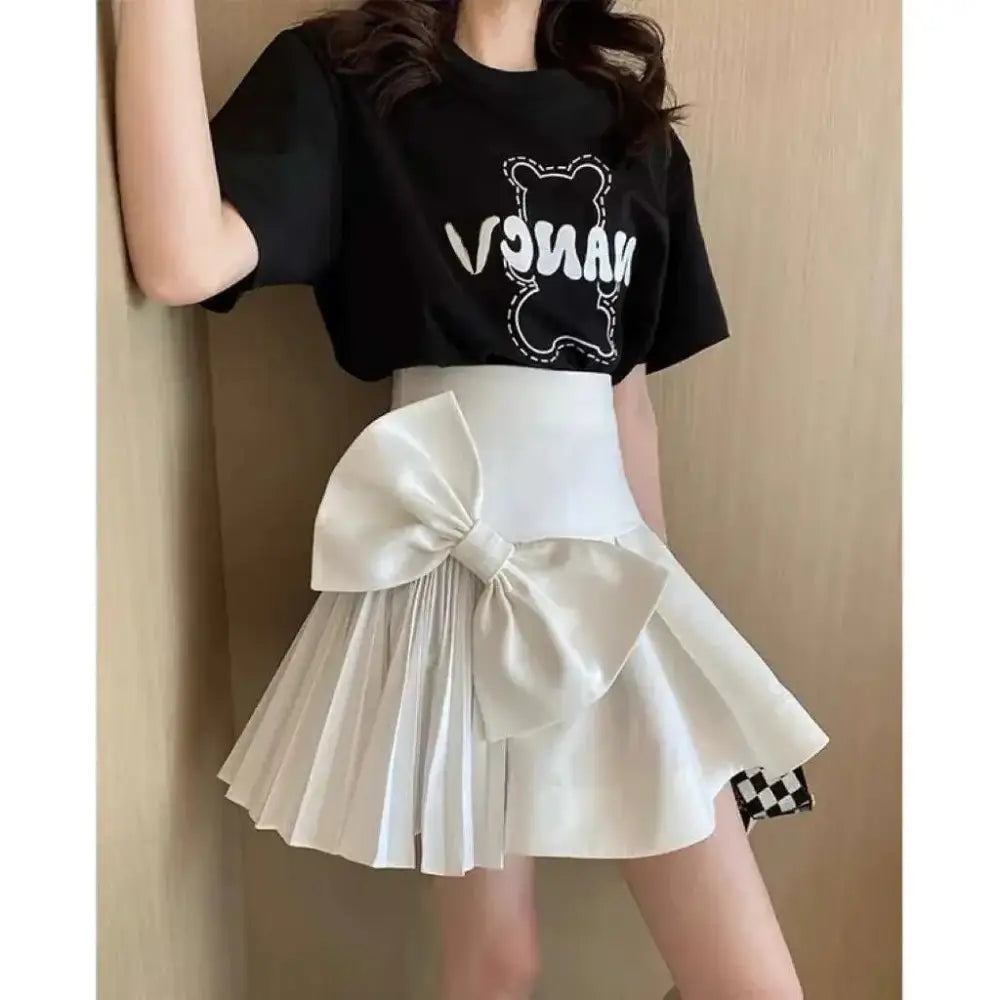 White high waist slimming pleated skirt with large satin waist slimming bow and chic mini skirt length