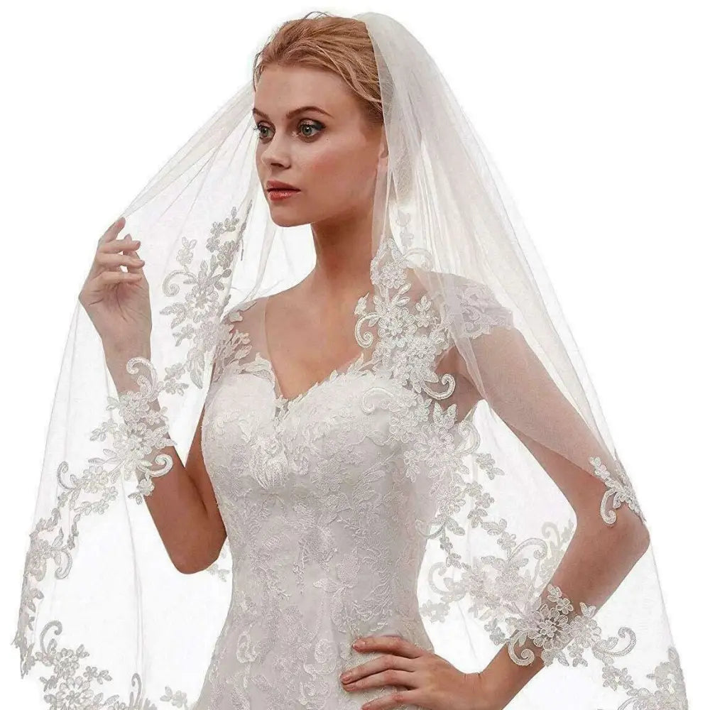Delicate white ivory bridal veil with intricate ivory embroidery applique floral detailing along the edges