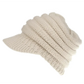 Cream-colored knitted women ponytail beanie with ribbed texture and soft slouchy brim suitable for casual wear