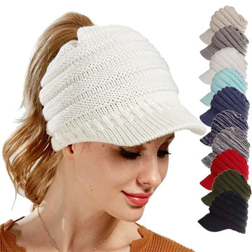 White knitted women ponytail beanie with a small brim suitable for stylish cold weather wear