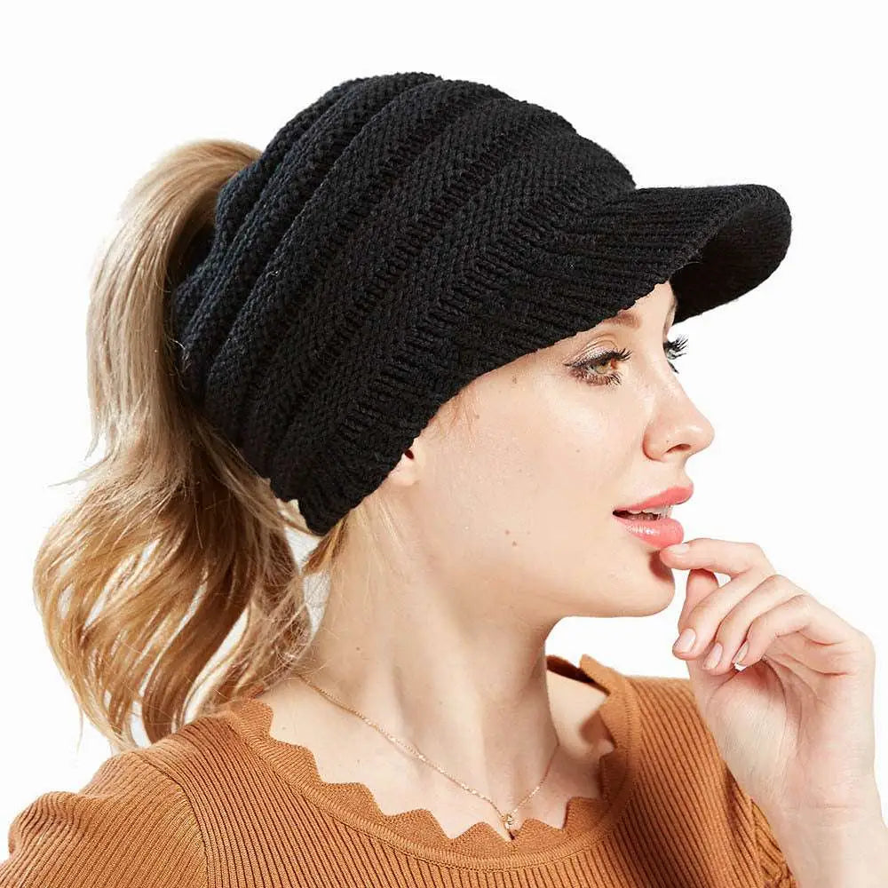 White knitted women ponytail beanie with a small brim suitable for stylish cold weather wear