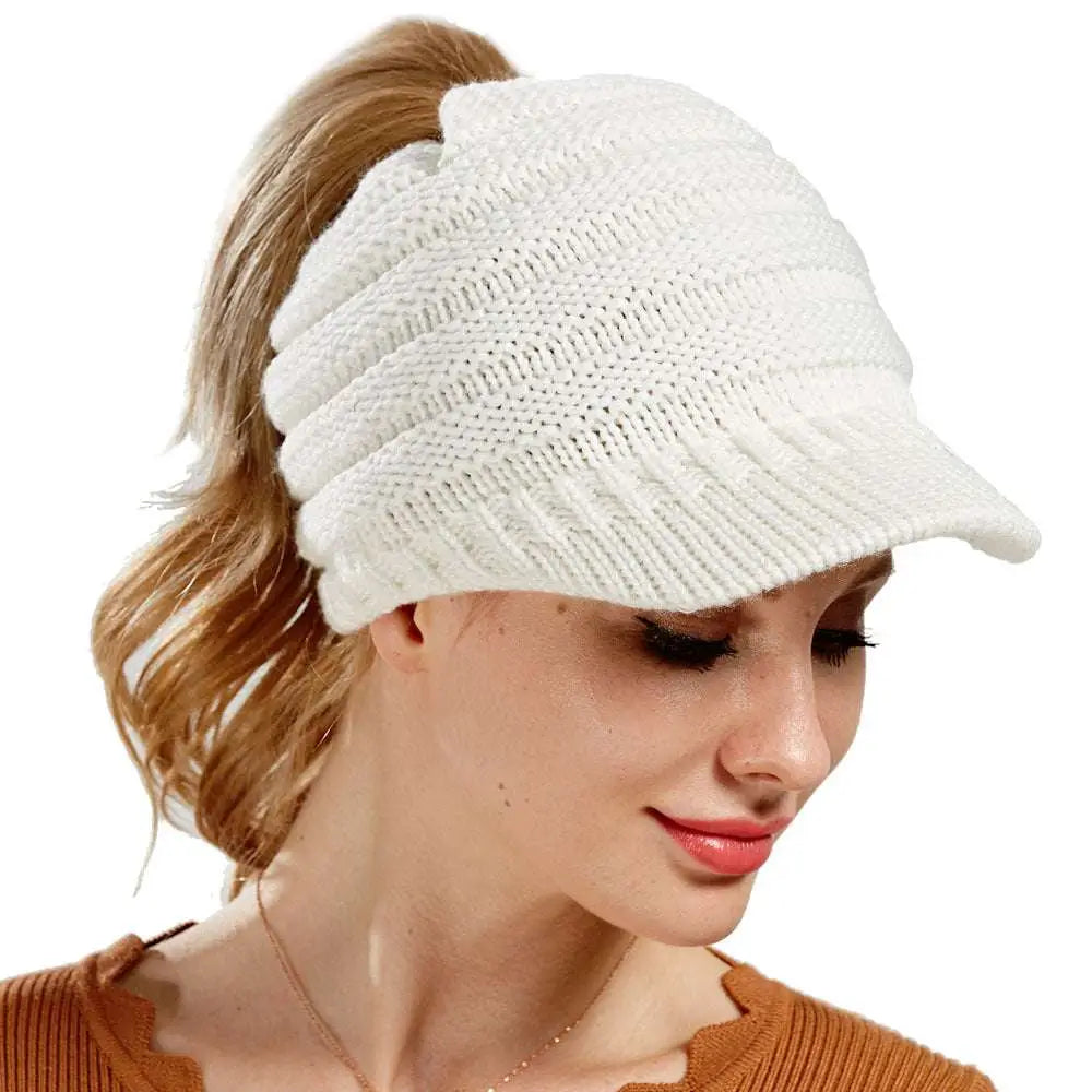 White knitted women ponytail beanie with a small brim suitable for stylish cold weather wear