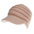 A soft beige knitted women ponytail beanie with a structured brim and ribbed texture suitable for brim use