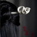 White knotted rope retro style hairpin featuring an intricately coiled snake design with a textured surface