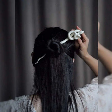White knotted rope retro style hairpin featuring an intricately coiled snake design for elegant hair styling
