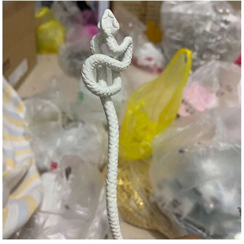 White knotted rope retro style hairpin featuring an intricately coiled snake figurine with textured scales and rope-like tail