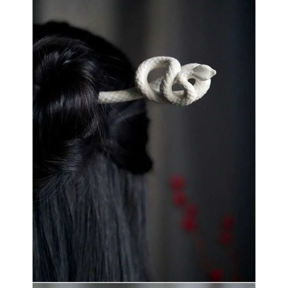 White knotted rope retro style hairpin with an intricately coiled snake design and smooth sculpted finish