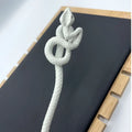 White knotted rope retro style hairpin featuring a white ceramic intricately coiled snake with textured scales