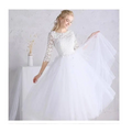 White lace floral wedding dress with small sleeves featuring lace detailing and a voluminous tulle skirt
