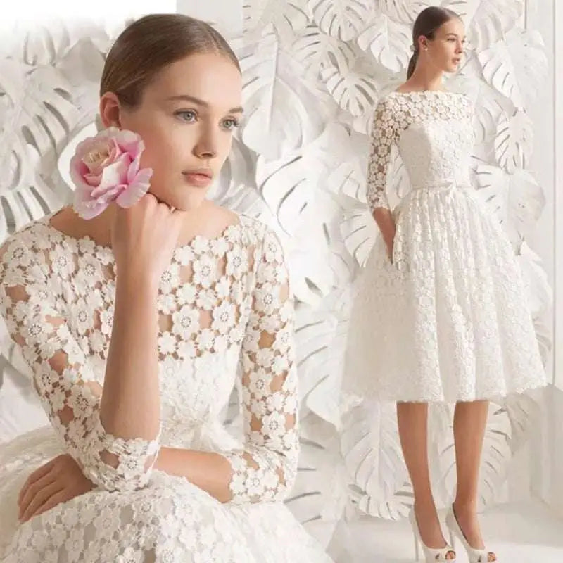 White lace floral wedding dress with small three-quarter length sleeves featuring intricate floral embroidery