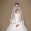 White lace floral bride veil with delicate embroidery along the edge for a white lace floral bridal look