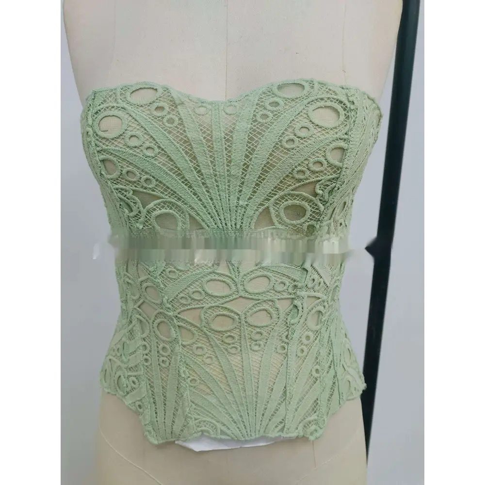 A delicate mint green lace hollow party club corset clothing with intricate circular and fan-shaped patterns
