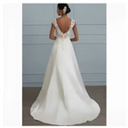 White lace satin a-line wedding gown with a flowing satin skirt and intricate lace back with cap sleeves shown from the back