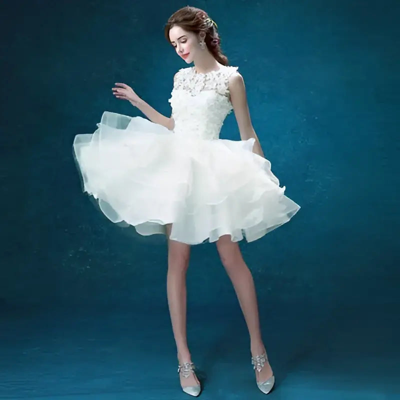 White lace tiered wedding short dress with short sleeves, delicate beading, and a tiered tulle skirt for brides