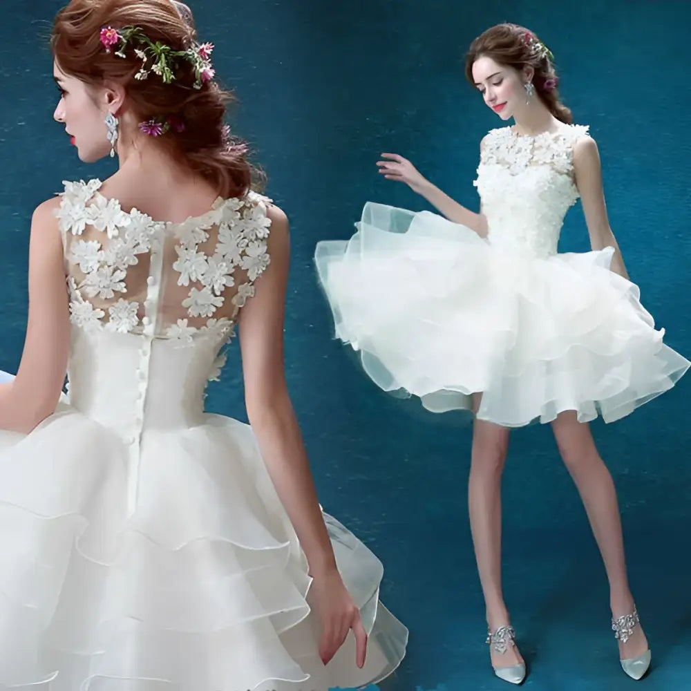 Back view of a white lace tiered wedding short dress with intricate floral lace and beading detailing on the sleeveless bodice