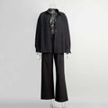 Black oversized shirt trousers suit with relaxed fit and frayed cuffs in contrast to white linen long sleeve shirt trousers suit