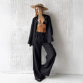 Black satin shirt trousers suit with relaxed fit and open front paired with matching white linen long sleeve cotton trousers