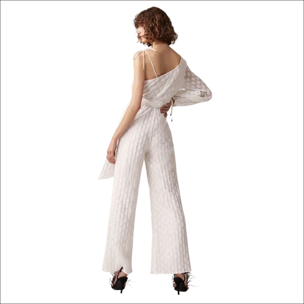 White luxury women’s fashion jumpsuit with textured fabric, one-shoulder design, sheer polka-dot sleeves, and belted waist jumpsuit image