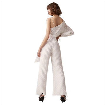 White luxury women’s fashion jumpsuit with textured fabric, one-shoulder design, sheer polka-dot sleeves, and belted waist jumpsuit image
