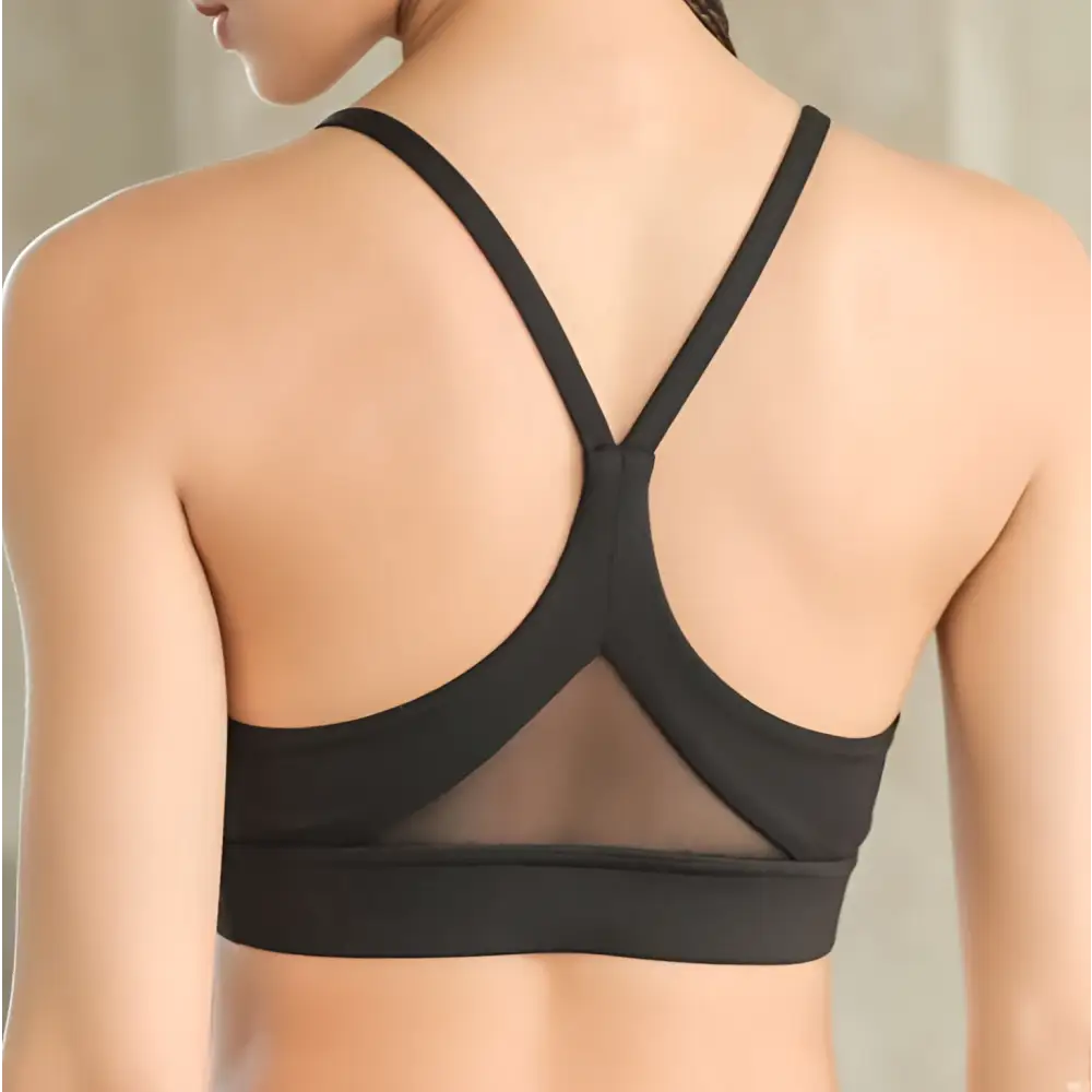 Black sports bra with crisscross back straps and mesh paneling showing fitness racerback bras design features
