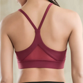 Back side of maroon fitness racerback bra with white mesh triangle push up design and crisscross straps