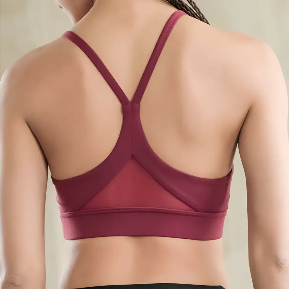 Back side of maroon fitness racerback bra with white mesh triangle push up design and crisscross straps