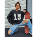 Black distressed graphic crew neck sweatshirt with white 15 print and ribbed knit cuffs and hem