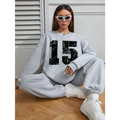 Gray graphic crew neck sweatshirt with black distressed 15 graphic and ribbed knit cuffs and hem